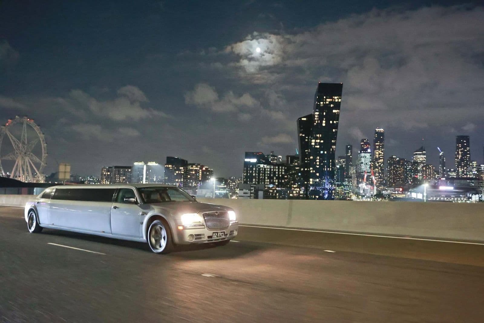 Signature stretch limousine at night with the Melbourne skyline