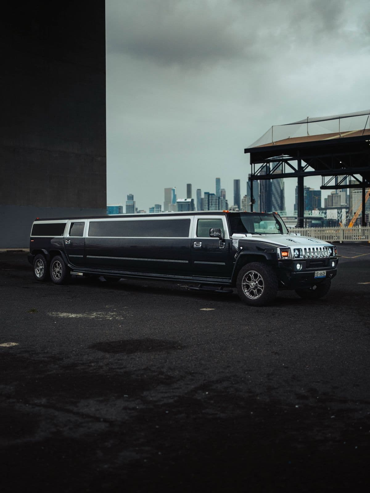 Black Hummer 6x6 stretch limousine with the Melbourne skyline at Docklands